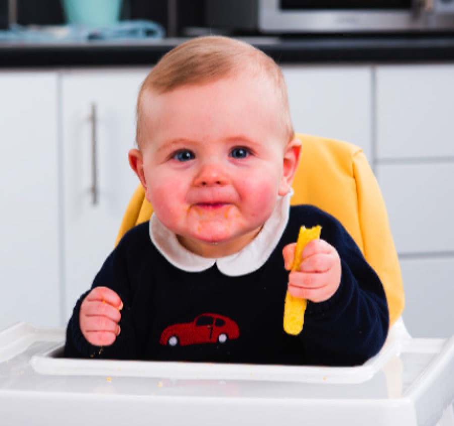Toddler eating Chloe's Organics JumboPuffs